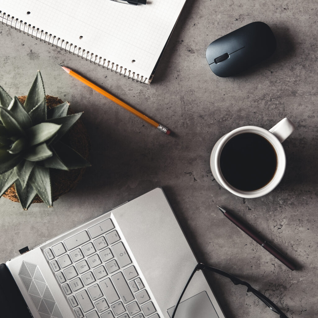 laptop and book, coffee on gray background, Top view of office desk on textured